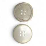Two beige buttons with four holes on a white background